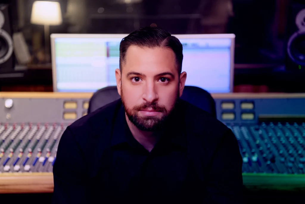 Roman Molino sitting with his back to his audio workstation
