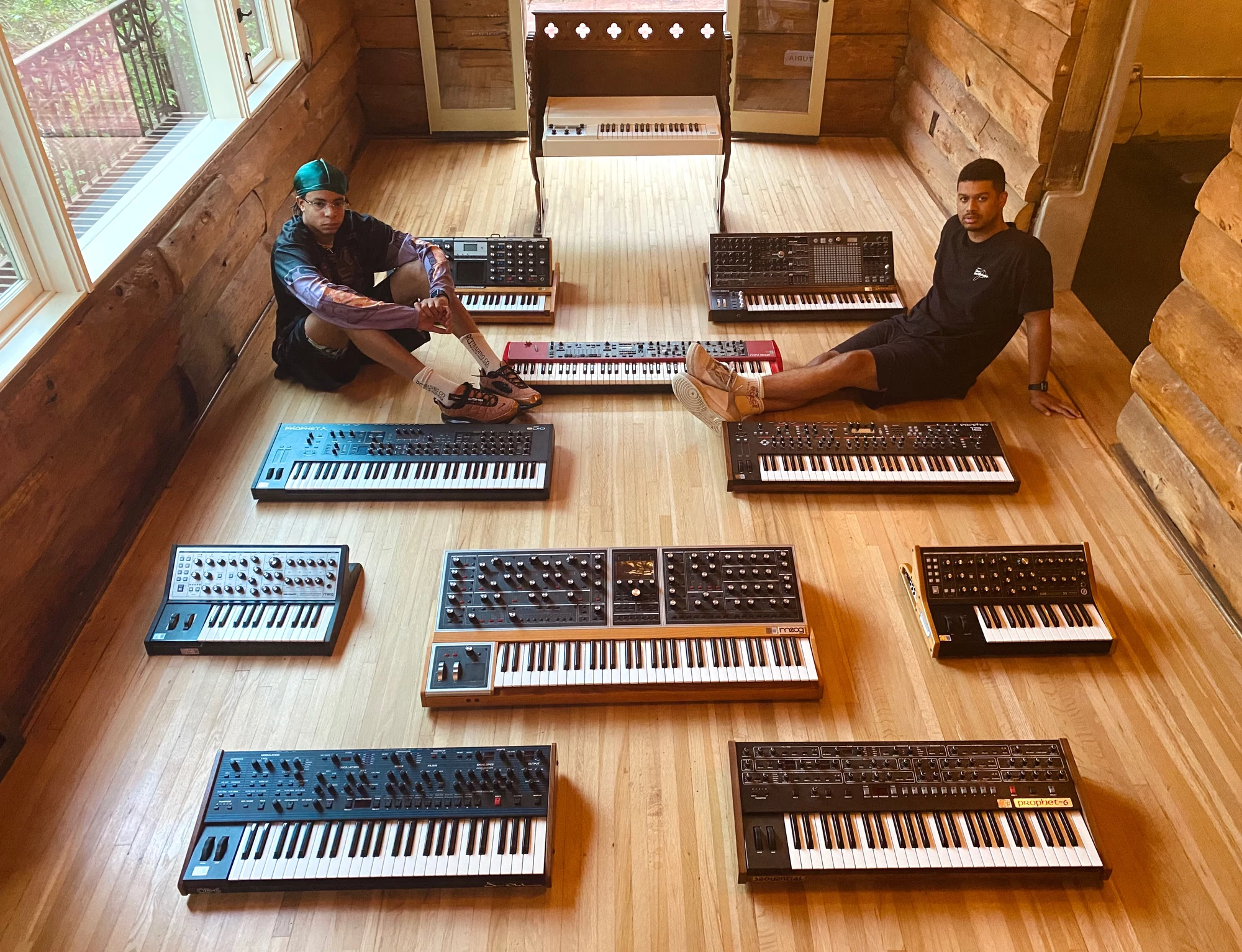 Take A Daytrip, aka Denzel and David sitting on the floor with their stable of synths.