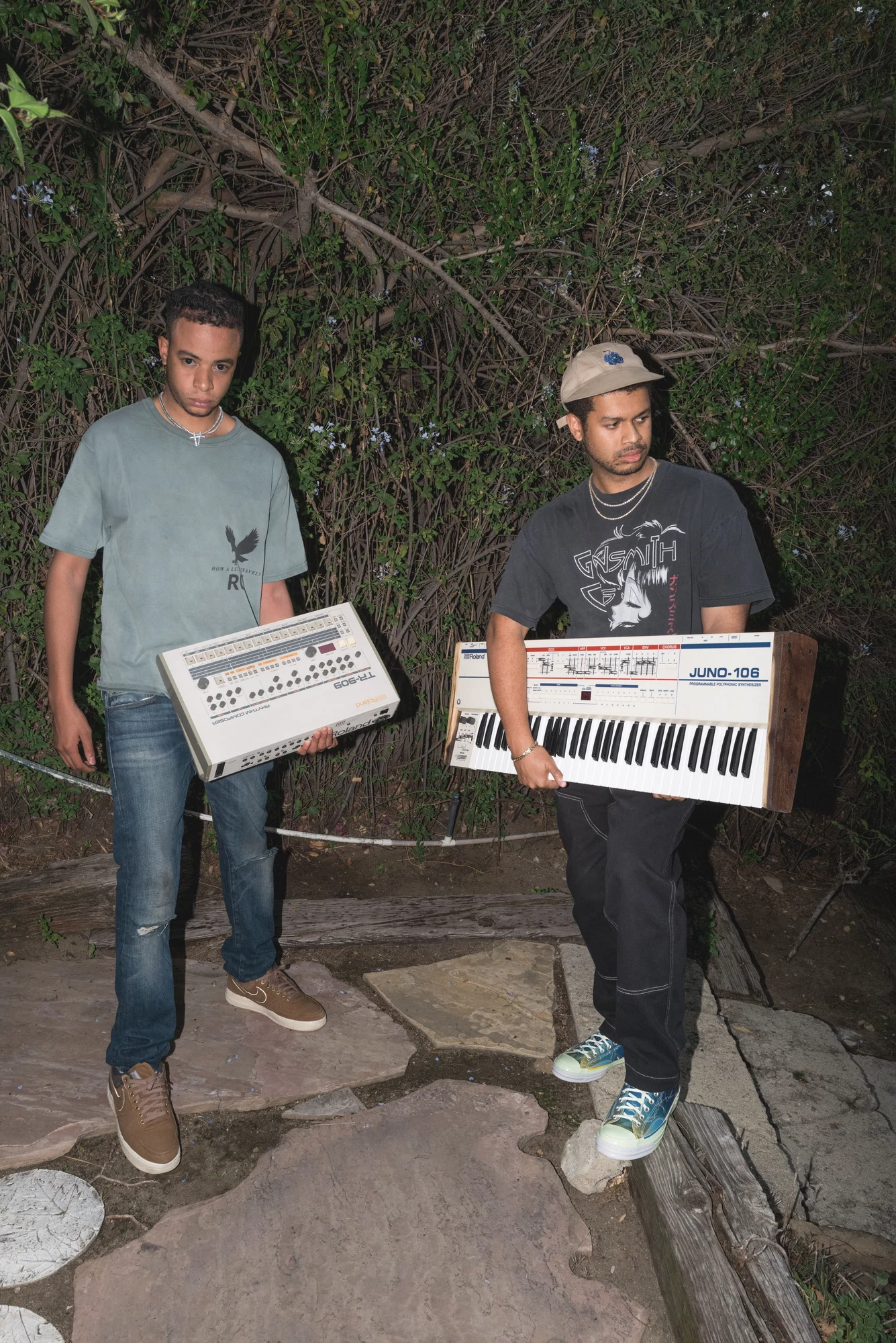 Take A Daytrip, Denzel holds a vintage Roland TR-909 drum machine while David carries a customized Roland Juno-106.