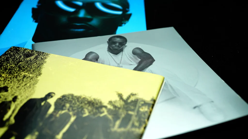 Three P.Diddy albums piled on a desk
