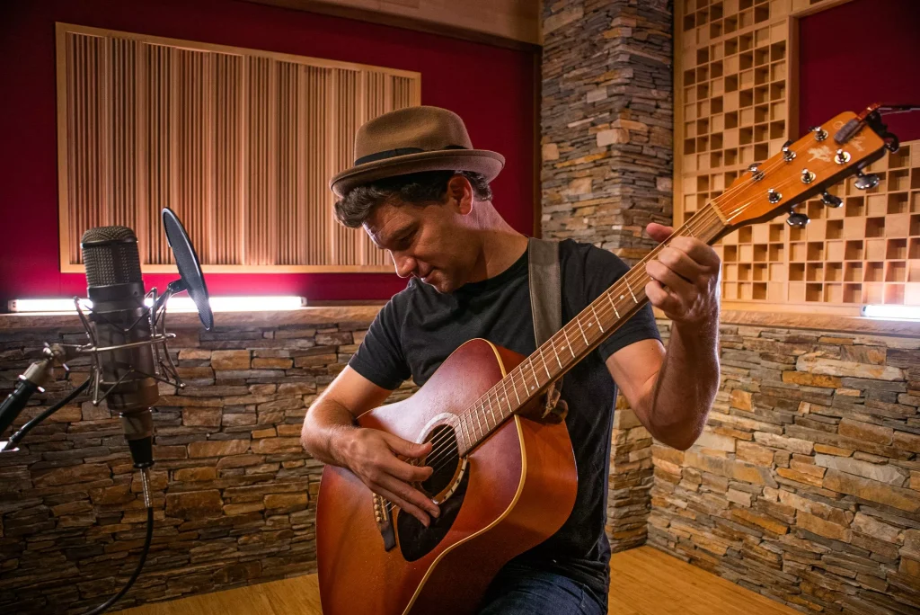 Eli Lev playing the guitar in the studio