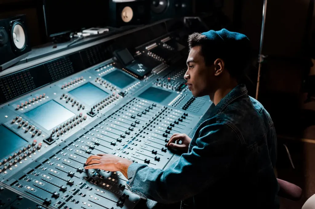 A man sitting at a mixing console