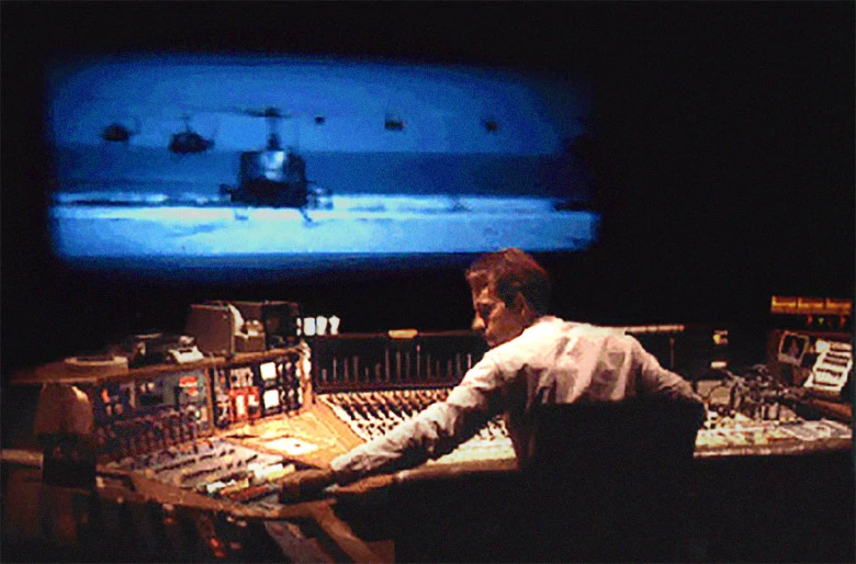 A man sitting in a dark studio