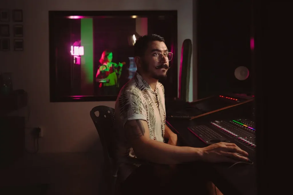 A man sitting in a dark studio