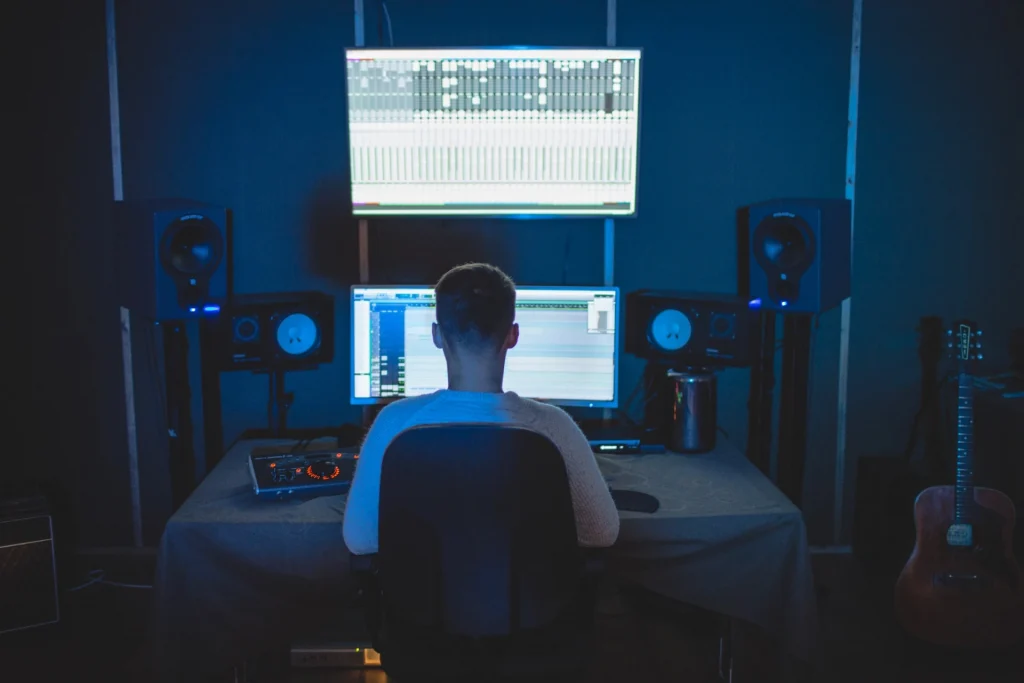 Man sitting at computer in a home studio