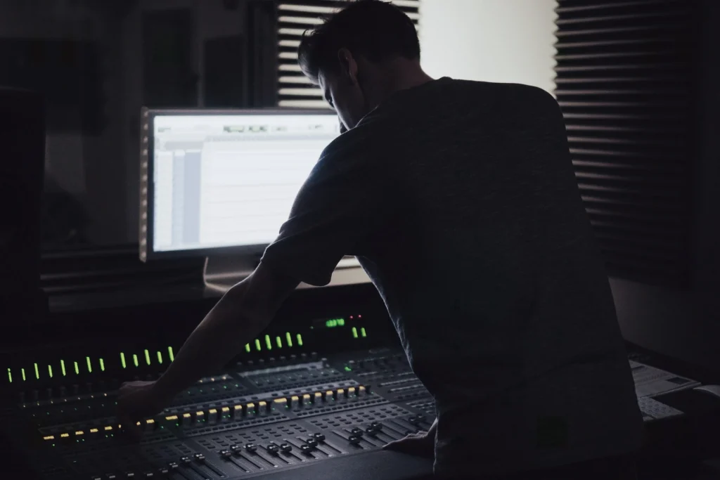 A man standing at an audio workstation