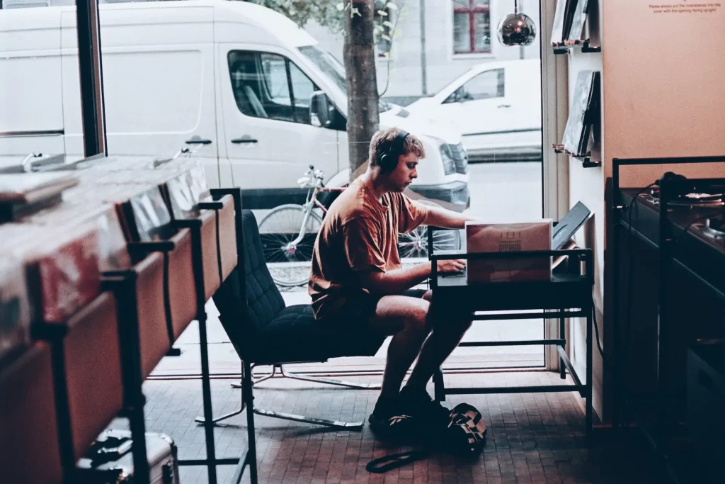 A man sitting at a table in a record store