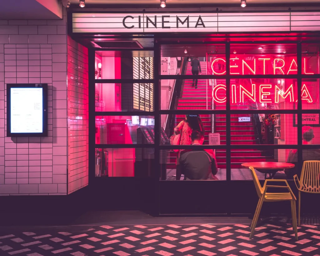 An red-toned image of the front of a cinema.
