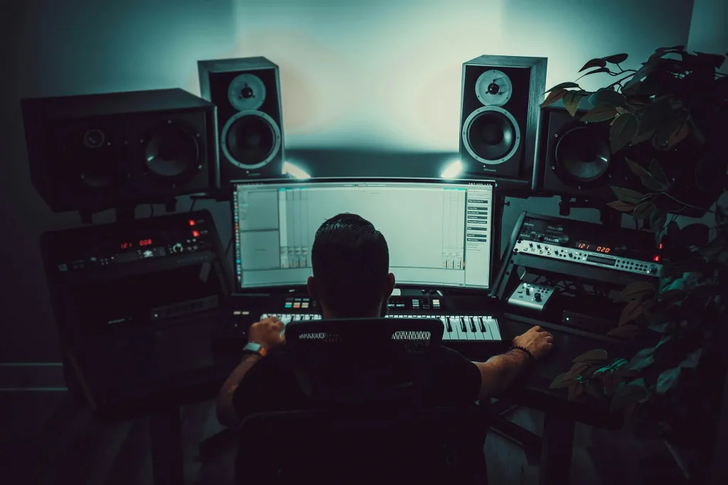 A man sitting in front of a computer in a studio