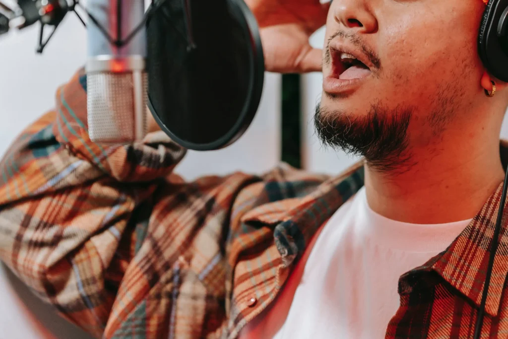 A close-up of a man singing into a microphone