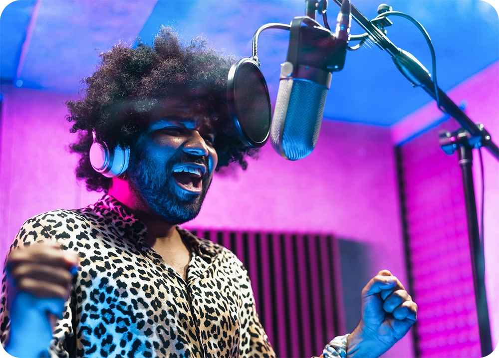 Man singing into a microphone in a studio