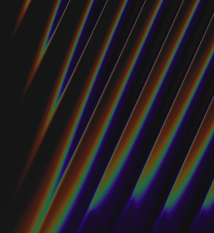 Black background with blue, orange, and green diagonal light waves